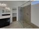 Modern bathroom with a walk-in shower, double vanity sinks, and an open walk-in closet at 12164 S 184Th Ave, Goodyear, AZ 85338