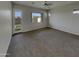 Bright bedroom featuring neutral walls, carpet, and a window with views to the fenced-in backyard at 12164 S 184Th Ave, Goodyear, AZ 85338