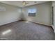 Large bedroom with carpet, neutral walls, and a bright window at 12164 S 184Th Ave, Goodyear, AZ 85338