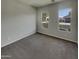 Neutral bedroom with carpet floors, natural light, and a closet at 12164 S 184Th Ave, Goodyear, AZ 85338