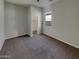 Spacious bedroom with carpet, a window, and a walk-in closet at 12164 S 184Th Ave, Goodyear, AZ 85338