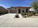 Charming single-story home featuring a desert landscape, a terracotta roof, and a two-car garage at 12164 S 184Th Ave, Goodyear, AZ 85338
