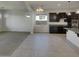 Open floor plan featuring kitchen with dark cabinetry and a large island at 12164 S 184Th Ave, Goodyear, AZ 85338