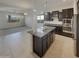 Open-concept kitchen featuring dark cabinetry, granite countertops, and stainless steel appliances at 12164 S 184Th Ave, Goodyear, AZ 85338