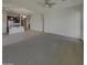 Spacious living room with neutral walls and carpet and access to the kitchen area at 12164 S 184Th Ave, Goodyear, AZ 85338