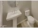 Neat powder room featuring a pedestal sink and toilet at 12164 S 184Th Ave, Goodyear, AZ 85338
