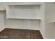 Walk-in closet featuring carpet and metal hanging rods for clothing and storage at 12164 S 184Th Ave, Goodyear, AZ 85338