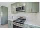 Updated kitchen featuring stainless steel appliances, marble countertops, modern cabinetry, and light wood floors at 1238 N 78Th St, Scottsdale, AZ 85257