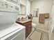Compact bathroom featuring stacked washer and dryer, vanity sink, and a toilet at 124 S 54Th St # 42, Mesa, AZ 85206