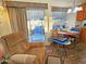 Cozy dining area with a table and chairs, sliding glass doors to the outside, and a comfortable recliner at 124 S 54Th St # 42, Mesa, AZ 85206