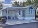 Inviting home with a covered carport, a landscaped yard, and a charming front porch at 124 S 54Th St # 42, Mesa, AZ 85206