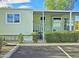 Charming home exterior with manicured landscaping, covered porch, and dedicated parking at 124 S 54Th St # 42, Mesa, AZ 85206