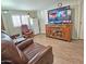 Bright living area boasting a large TV, hardwood floors, and comfortable leather recliner seating at 124 S 54Th St # 42, Mesa, AZ 85206