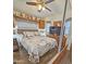 A comfortable bedroom with a Paris themed comforter, tv, and a ceiling fan at 124 S 54Th St # 42, Mesa, AZ 85206