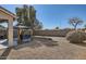 Gravel backyard with patio, gazebo with seating, grill, and desert landscaping at 14532 N 146Th Ln, Surprise, AZ 85379