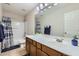 Bathroom featuring a shower/tub combo, single sink vanity, and tile floors at 14532 N 146Th Ln, Surprise, AZ 85379