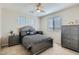 Bedroom with a ceiling fan, three windows, and gray matching furniture set at 14532 N 146Th Ln, Surprise, AZ 85379