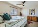 Bedroom featuring a ceiling fan, window with blinds, closet, and dresser with art at 14532 N 146Th Ln, Surprise, AZ 85379