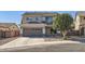 Two-story home featuring a gray exterior, attached garage, and manicured landscaping at 14532 N 146Th Ln, Surprise, AZ 85379
