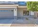 Inviting front porch with security door, leading to a well-maintained home with a two-car garage at 14532 N 146Th Ln, Surprise, AZ 85379