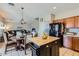 Open-concept kitchen with an island seamlessly flows into the dining and living areas at 14532 N 146Th Ln, Surprise, AZ 85379