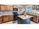 Well-lit kitchen with an island, ample cabinets, stylish backsplash, and modern appliances at 14532 N 146Th Ln, Surprise, AZ 85379