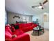 Inviting living room with a large red sectional couch and themed decor at 14532 N 146Th Ln, Surprise, AZ 85379