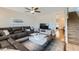 Comfortable living room with plush sectional, ceiling fan, and seamless flow to the staircase at 14532 N 146Th Ln, Surprise, AZ 85379
