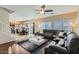 Spacious living room featuring a sectional sofa, ceiling fan, and ample natural light at 14532 N 146Th Ln, Surprise, AZ 85379