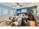 Well-lit main bedroom featuring a ceiling fan, blue accent wall, and tasteful furnishings at 14532 N 146Th Ln, Surprise, AZ 85379