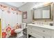 Bright bathroom featuring a white vanity, framed mirror, and colorful shower curtain at 1901 W Mulberry Dr, Chandler, AZ 85286