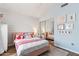 Charming bedroom with pastel colors, wood floors, large mirror doors, and cozy, inviting bed at 1901 W Mulberry Dr, Chandler, AZ 85286