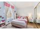 Charming bedroom featuring a pink bed, stylish decor, and natural light from a window at 1901 W Mulberry Dr, Chandler, AZ 85286