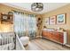 Well-organized Bedroom featuring stylish dresser, crib, tropical drapes, and lots of storage at 1901 W Mulberry Dr, Chandler, AZ 85286