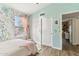 Bright bedroom with colorful wallpaper, white closets, window, and hardwood flooring at 1901 W Mulberry Dr, Chandler, AZ 85286