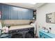 Well-organized laundry room with front-load machines, a folding counter, and ample cabinet storage at 1901 W Mulberry Dr, Chandler, AZ 85286