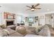 Inviting living room featuring a brick fireplace, ceiling fan, and comfortable sectional sofa at 1901 W Mulberry Dr, Chandler, AZ 85286