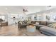 Bright living room boasts a spacious sectional sofa and open layout to the adjacent kitchen area at 1901 W Mulberry Dr, Chandler, AZ 85286