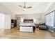 Main bedroom with wood floors, ceiling fan, and sitting area at 1901 W Mulberry Dr, Chandler, AZ 85286