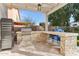 Outdoor kitchen with built-in gas grill and stone backsplash at 1901 W Mulberry Dr, Chandler, AZ 85286