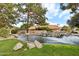 Scenic community pond with a rock waterfall and mature landscaping at 1901 W Mulberry Dr, Chandler, AZ 85286