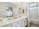 Bright bathroom featuring double sinks, a large mirror, and access to the toilet and tub at 20218 N 33Rd Pl, Phoenix, AZ 85050