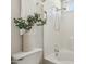 A bathtub and tiled shower with white towels and small greenery for natural accent at 20218 N 33Rd Pl, Phoenix, AZ 85050
