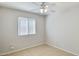 Bedroom featuring ceiling fan, tiled floor, a large window, and neutral walls at 20218 N 33Rd Pl, Phoenix, AZ 85050