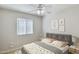 Bright bedroom with a comfortable bed, neutral decor, and a large window, creating a peaceful environment at 20218 N 33Rd Pl, Phoenix, AZ 85050
