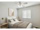 Comfortable bedroom with a queen bed, soft bedding, and a bright window, offering a relaxing atmosphere at 20218 N 33Rd Pl, Phoenix, AZ 85050