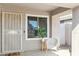 Covered entryway features a security door, window, and charming white wicker chair at 20218 N 33Rd Pl, Phoenix, AZ 85050