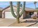 Home exterior featuring desert landscaping and a cactus in the front yard at 20218 N 33Rd Pl, Phoenix, AZ 85050