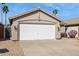 Exterior of the home showing a two-car garage and desert landscaping with palm trees at 20218 N 33Rd Pl, Phoenix, AZ 85050