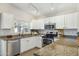 Bright kitchen featuring stainless appliances, granite countertops, and white cabinetry at 20218 N 33Rd Pl, Phoenix, AZ 85050